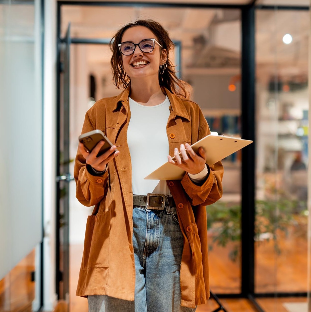 Smiling business owner holding paperwork